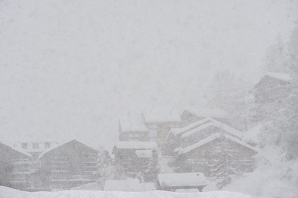 rural snowy village during severe blizzard